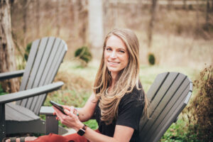 Image of Laura Schoenfeld with phone used for blog about burnout from content creation