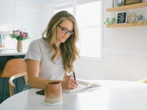 Business Coach Laura Schoenfeld celebrating wins through writing and journaling